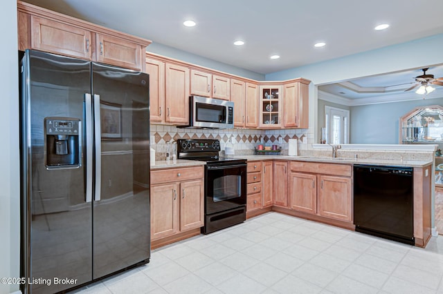 kitchen with glass insert cabinets, ornamental molding, a peninsula, black appliances, and backsplash