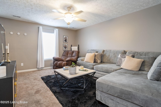 living room with visible vents, baseboards, a ceiling fan, a textured ceiling, and carpet floors