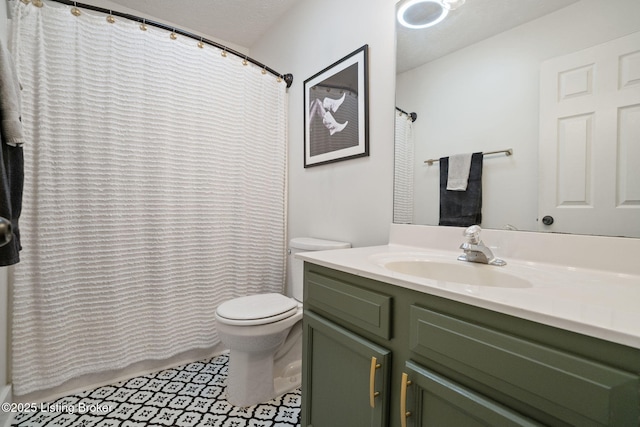 bathroom featuring toilet, vanity, and a shower with curtain