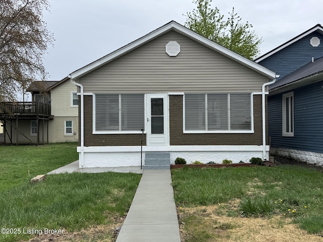 bungalow-style home featuring a front yard