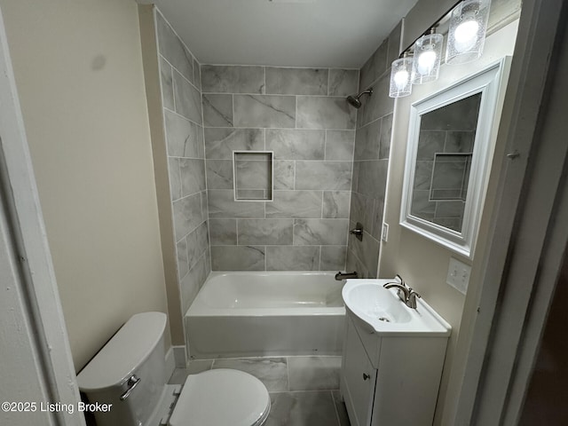 bathroom with toilet, vanity, marble finish floor, and shower / bathtub combination