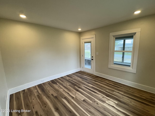 interior space with recessed lighting, dark wood-style floors, and baseboards