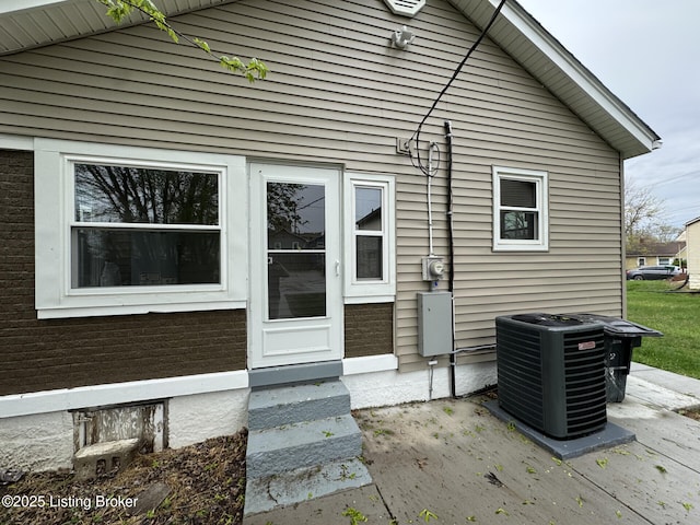 back of house with central air condition unit and entry steps