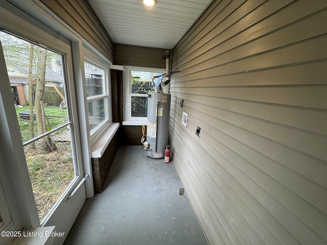 unfurnished sunroom with gas water heater