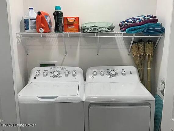 washroom featuring separate washer and dryer and laundry area