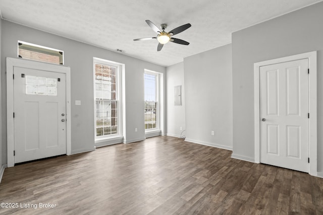 foyer with visible vents, baseboards, ceiling fan, a textured ceiling, and dark wood-type flooring