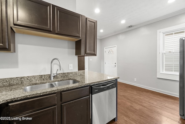 kitchen with crown molding, appliances with stainless steel finishes, a sink, and dark brown cabinets