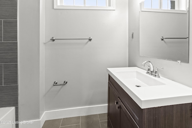 bathroom with tile patterned floors, vanity, and baseboards