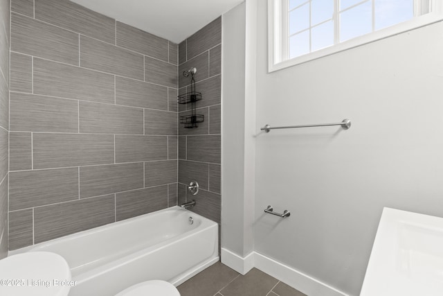 full bathroom with toilet, tile patterned floors, baseboards, and shower / bath combination