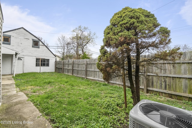 view of yard featuring central AC unit and a fenced backyard
