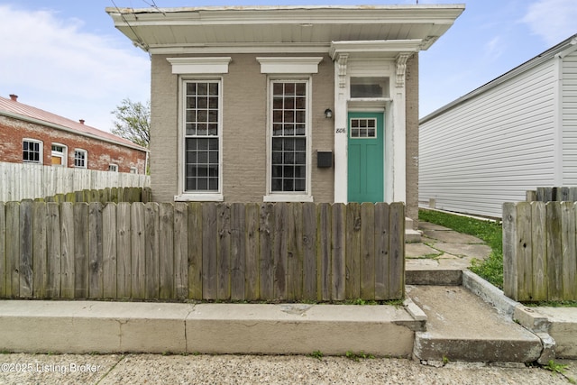 entrance to property featuring fence