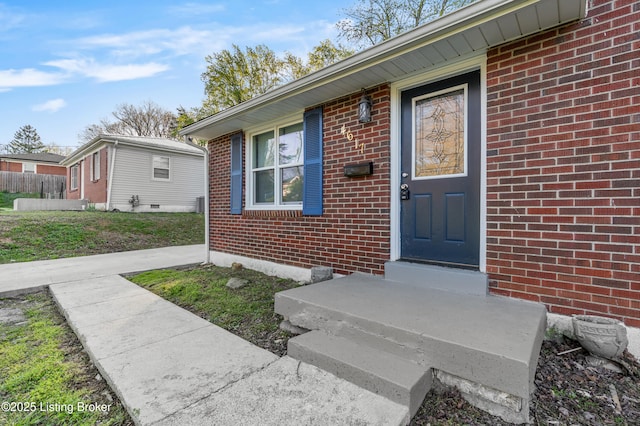 doorway to property featuring brick siding