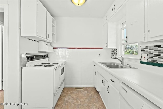 kitchen featuring visible vents, a sink, light countertops, white appliances, and white cabinetry