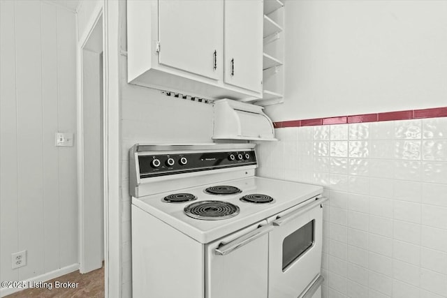 kitchen featuring electric stove, white cabinetry, open shelves, light countertops, and tile walls