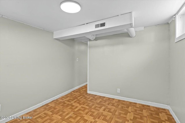 basement featuring baseboards and visible vents