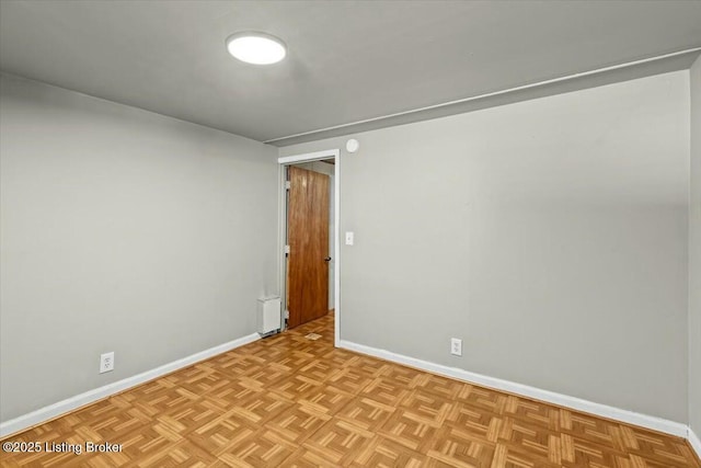 unfurnished room with baseboards
