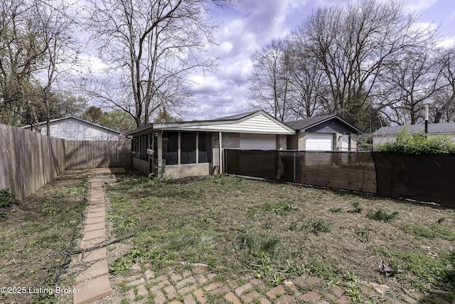 1125 W Whitney Ave, Louisville, KY 40215 - rear view of house featuring a fenced backyard and a sunroom