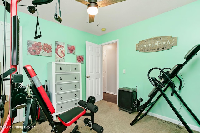 exercise area with ceiling fan, baseboards, and carpet floors