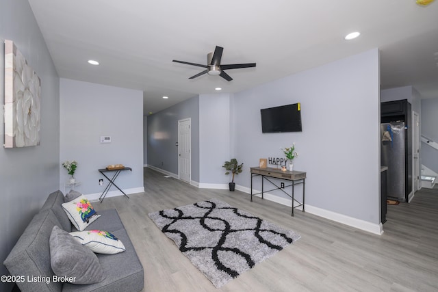 living area with baseboards, a ceiling fan, wood finished floors, and recessed lighting