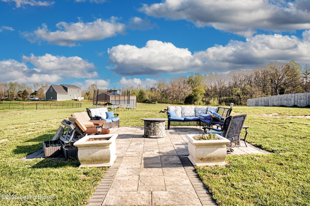 view of patio / terrace featuring fence and an outdoor living space with a fire pit