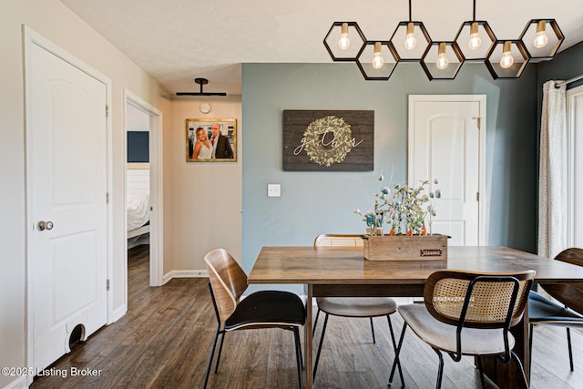 dining room with baseboards and dark wood finished floors