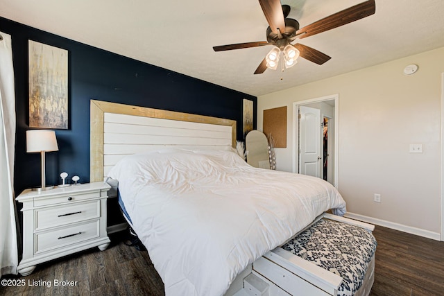 bedroom featuring wood finished floors, baseboards, and ceiling fan