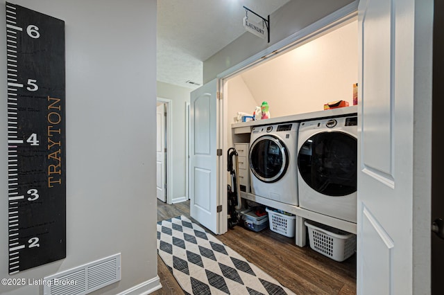 laundry room with visible vents, wood finished floors, laundry area, and independent washer and dryer