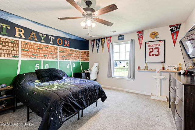 carpeted bedroom with a textured ceiling, a ceiling fan, baseboards, and visible vents
