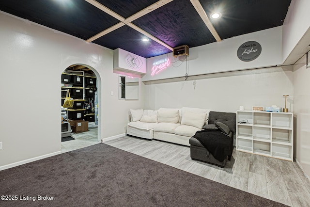 living room with wood finished floors, baseboards, arched walkways, and recessed lighting