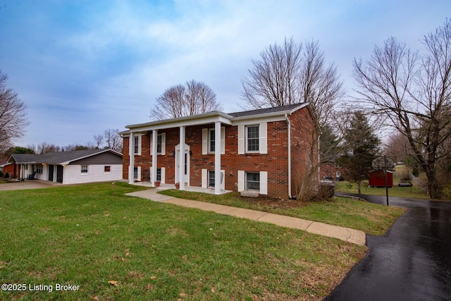 view of front facade with a front yard and brick siding