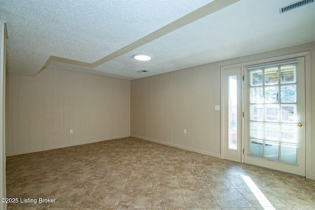 spare room featuring visible vents and a textured ceiling
