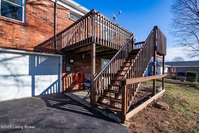 exterior space featuring driveway, a garage, and stairs