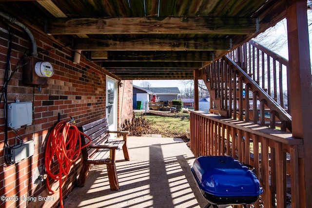 view of patio with a grill and stairs