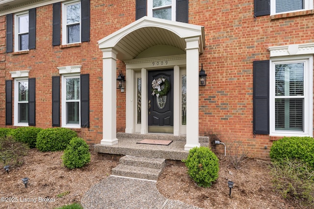 property entrance with brick siding