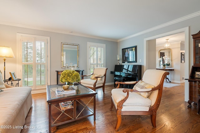 living area featuring crown molding, wood finished floors, and baseboards