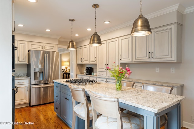 kitchen with hanging light fixtures, crown molding, recessed lighting, and stainless steel appliances