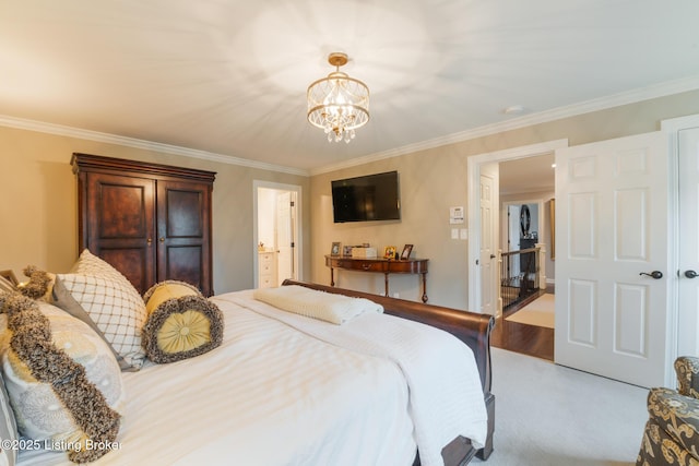 bedroom with crown molding, ensuite bathroom, and a notable chandelier