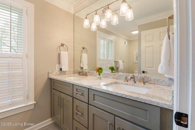 full bathroom with a sink, toilet, double vanity, and crown molding