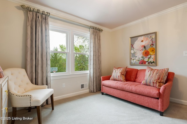 living area with baseboards, ornamental molding, and carpet floors