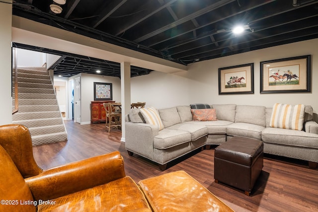 living area featuring wood finished floors and stairway
