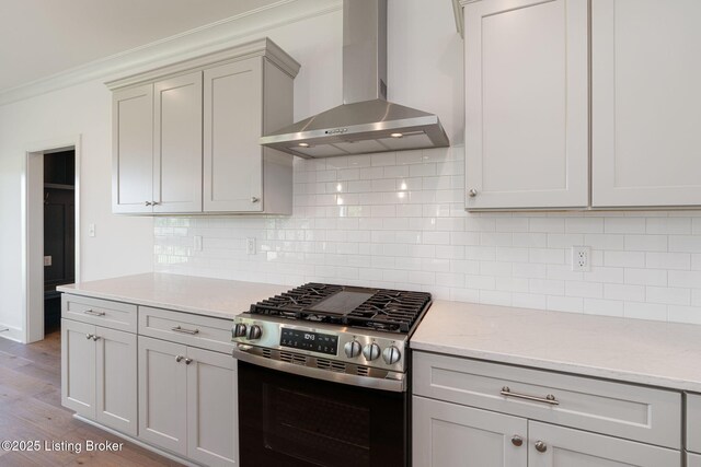 3238 Catalpa Farms Dr, Fisherville, KY 40023 - kitchen featuring wall chimney range hood, stainless steel range with gas stovetop, ornamental molding, wood finished floors, and backsplash