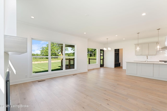 3238 Catalpa Farms Dr, Fisherville, KY 40023 - unfurnished living room with light wood-style floors, recessed lighting, a sink, baseboards, and crown molding