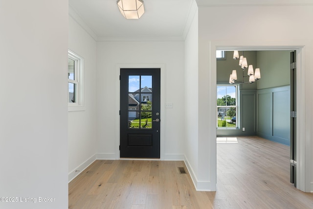 3238 Catalpa Farms Dr, Fisherville, KY 40023 - foyer featuring crown molding, a chandelier, light wood finished floors, and healthy amount of natural light
