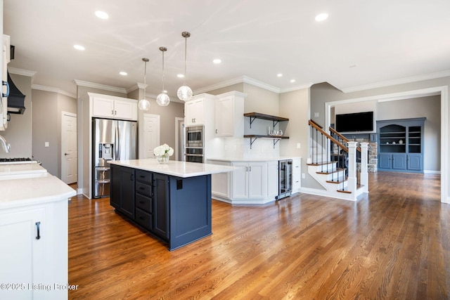 kitchen featuring light countertops, appliances with stainless steel finishes, white cabinets, and open shelves