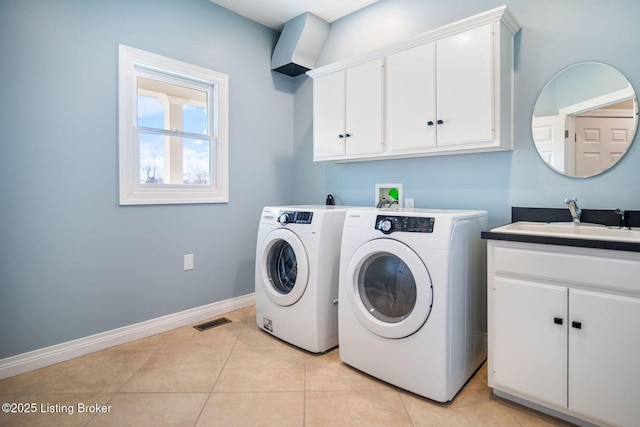 clothes washing area featuring independent washer and dryer, visible vents, cabinet space, a sink, and baseboards