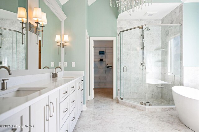 full bathroom featuring double vanity, a sink, and a shower stall