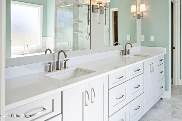 full bath with a sink, an inviting chandelier, a stall shower, and double vanity
