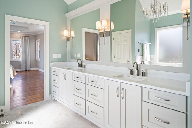 bathroom with crown molding, a sink, lofted ceiling, and a notable chandelier