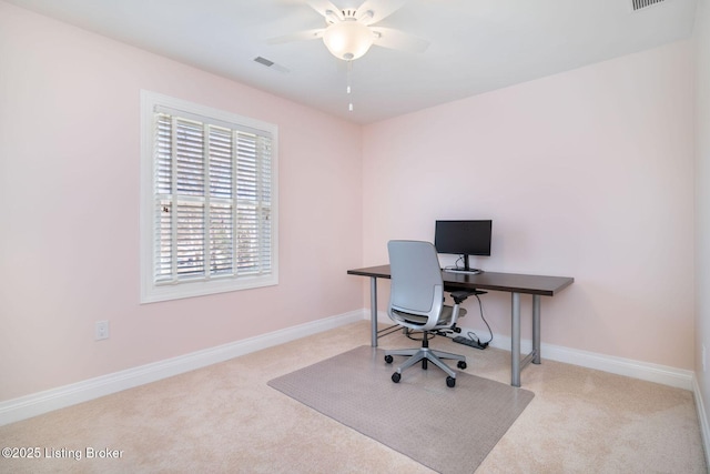 carpeted office featuring visible vents, a ceiling fan, and baseboards