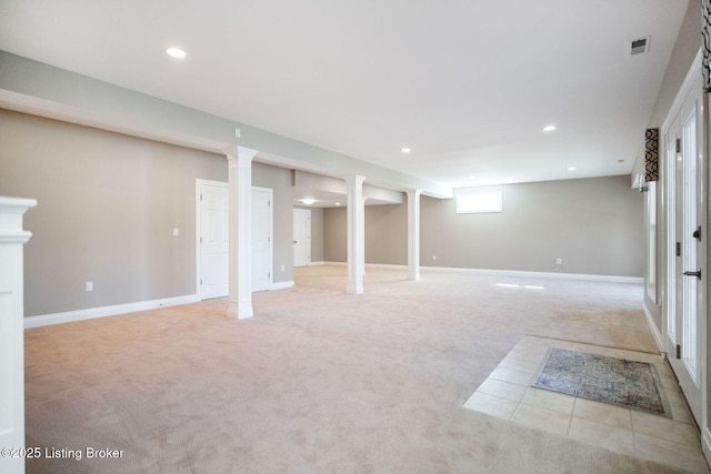 basement with visible vents, recessed lighting, baseboards, and light carpet